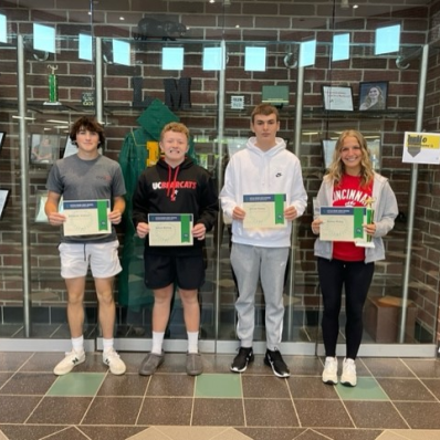 students smiling holding certificate